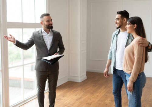 Estate Agent Showing Property For Young Buyers