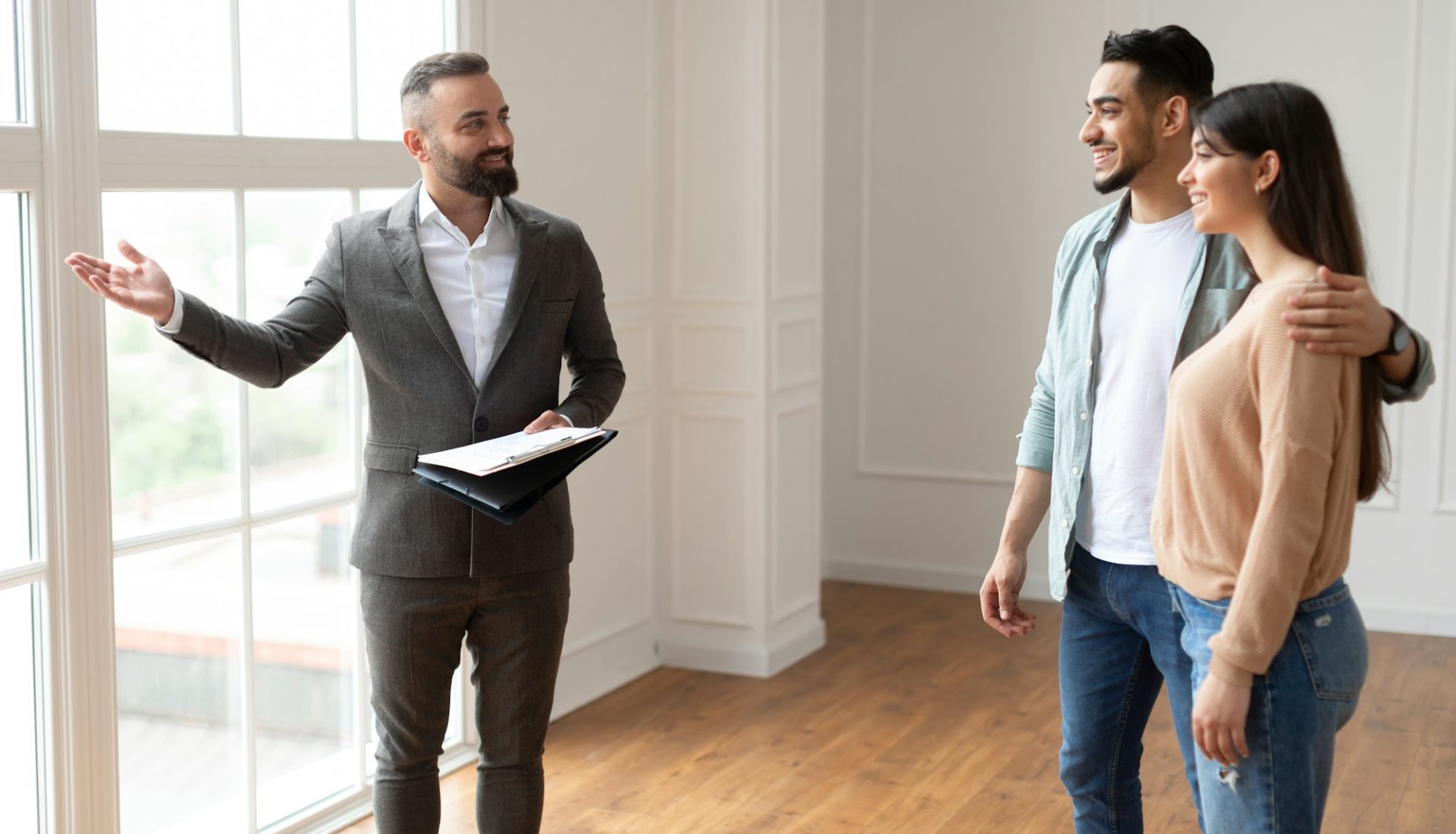 Estate Agent Showing Property For Young Buyers